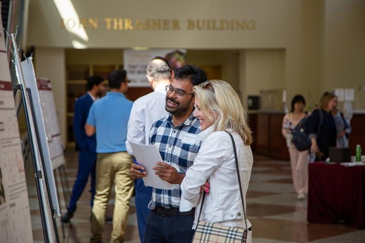 photo of two people looking at research poster
