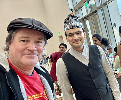 photo of engineering undergrad aashutosh pokharel with fsu graduate school dean mark riley at international festival