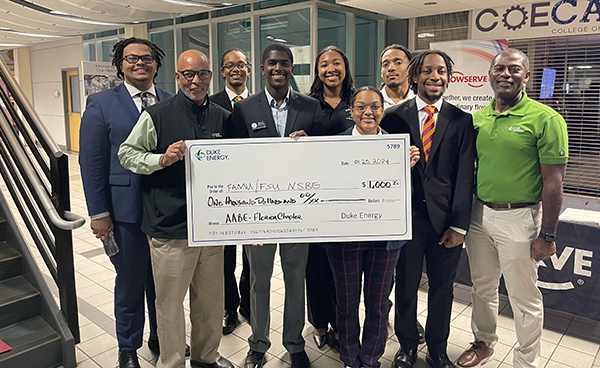 photo of nsbe students accepting a check from duke energy at the famu-fsu college of engineering