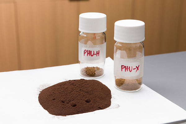 photo of dark brown powder and tubes marked PHU-H/X