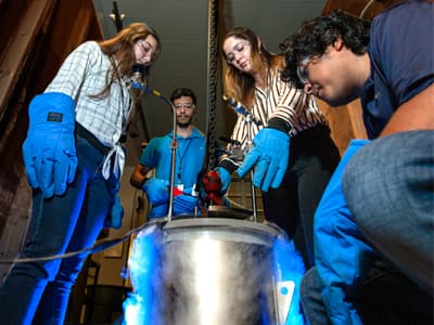 Four students in a laboratory conducting an experiment