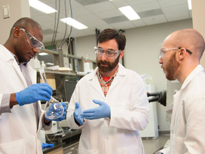 3 students working in a research lab