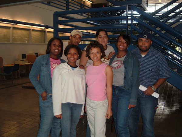 group of students standing in front of blue staircase