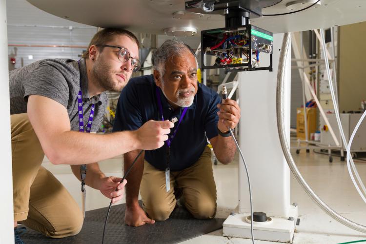 Dr. Sam McCalpin (left) and Dr. Ayyalusamy "Rams" Ramamoorthy hookup a probe in the bore of a magnet at the National High Magnetic Field Laboratory (NHMFL) in Tallahassee, Florida on July 19, 2024.