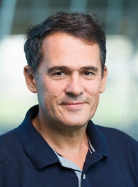 headshot of man in blue shirt