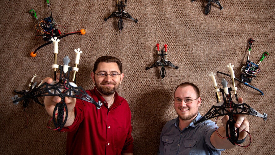 Dr Jonathan Clark, left, and graduate student Jason Brown with some of their climbing robots at CISCOR in the FAMU-FSU College of Engineering in Tallahassee, Florida February 22, 2019.