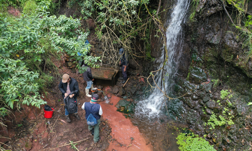 Image of locals and students at site of new clean water site.