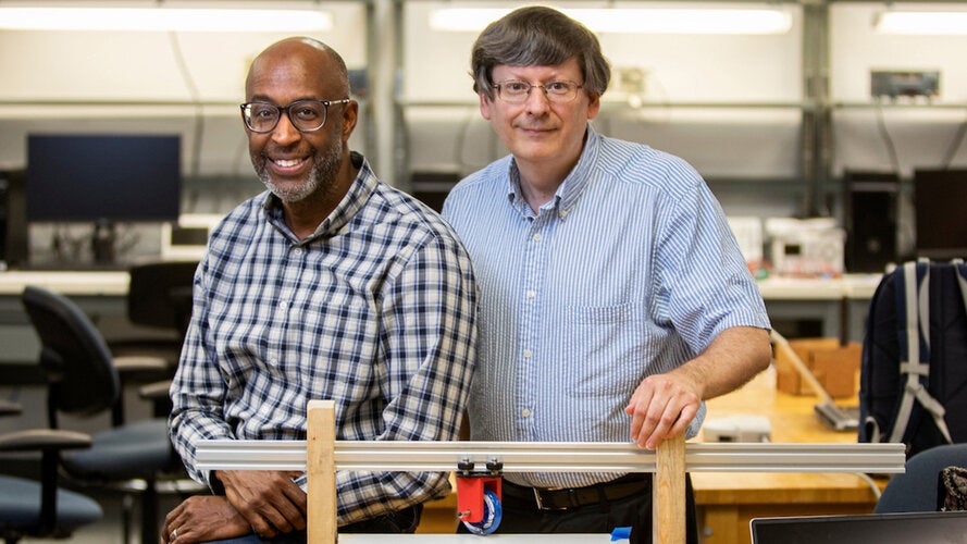Carl Moore Ph.D., an associate professor in mechanical engineering and electrical and computer engineering professor Rodney Roberts, Ph.D. with a prototype.