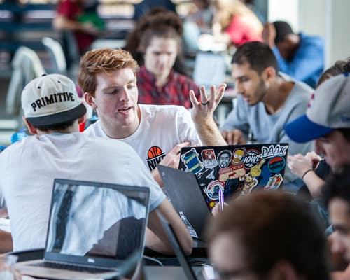 Male students discussing their class project.