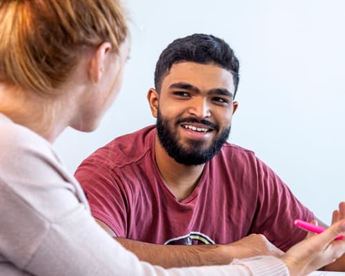Male students discussing their class project.