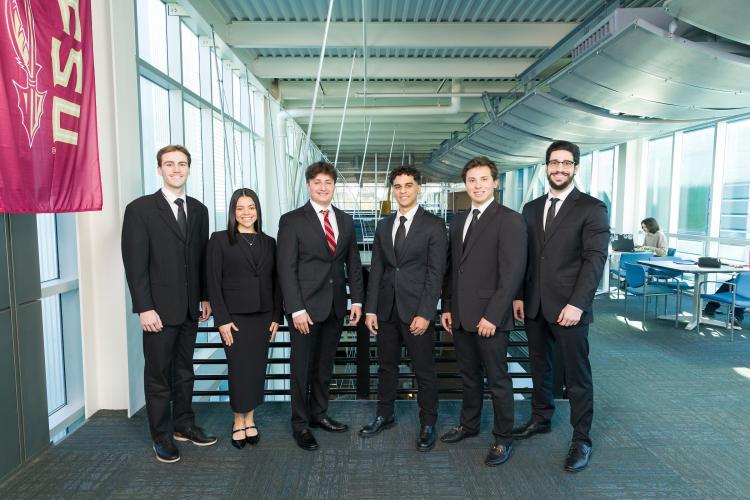 The six members of engineering senior design team 111 stand together on the third floor breezeway at the FAMU-FSU College of Engineering.