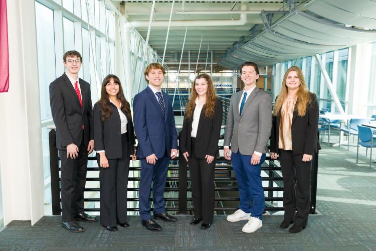 The six members of engineering senior design team 120/403 stand together on the third floor breezeway at the FAMU-FSU College of Engineering.