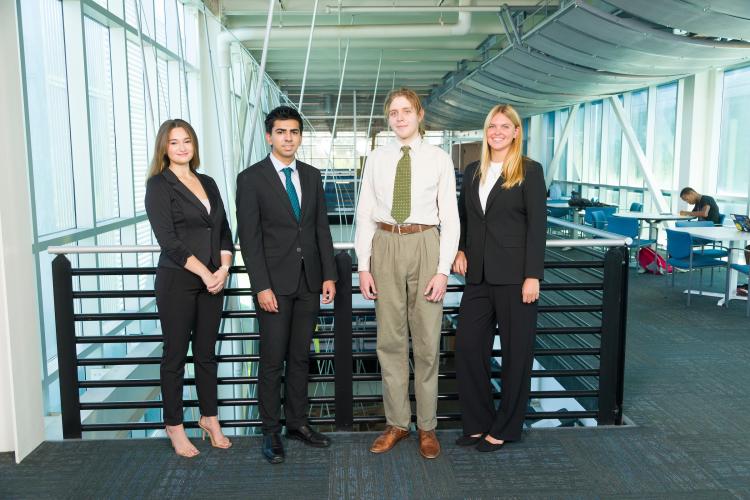 The four members of engineering senior design team 202 stand together on the third floor breezeway at the FAMU-FSU College of Engineering.
