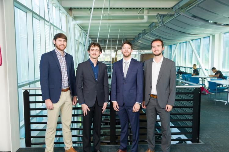 The four members of engineering senior design team 203 stand together on the third floor breezeway at the FAMU-FSU College of Engineering.
