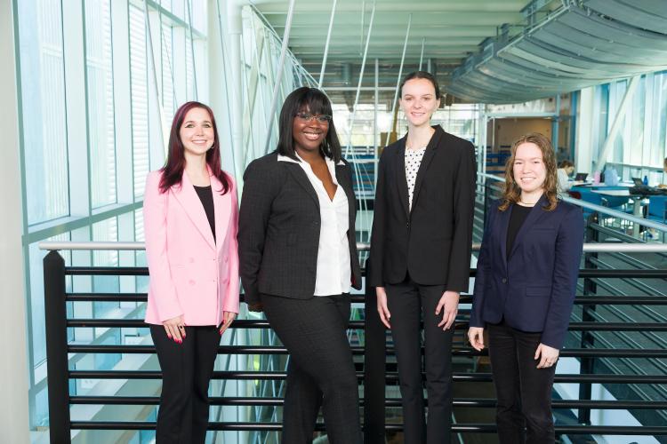 The four members of engineering senior design team 206 stand together on the third floor breezeway at the FAMU-FSU College of Engineering.