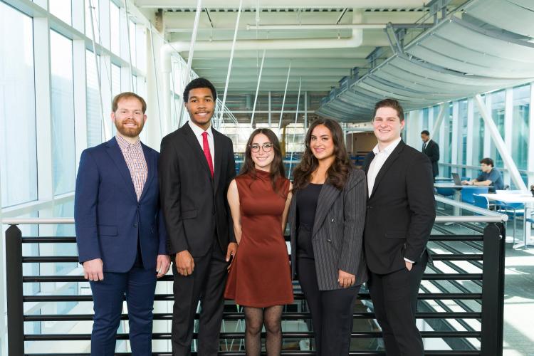 The five members of engineering senior design team 211 stand together on the third floor breezeway at the FAMU-FSU College of Engineering.