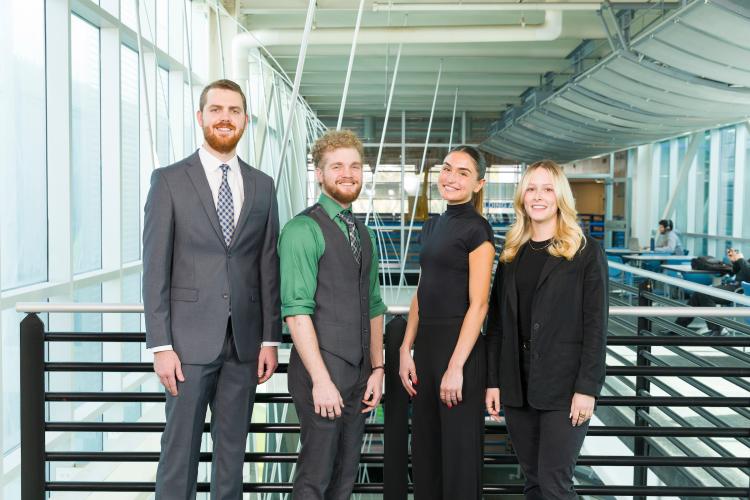 The four members of engineering senior design team 215 stand together on the third floor breezeway at the FAMU-FSU College of Engineering.