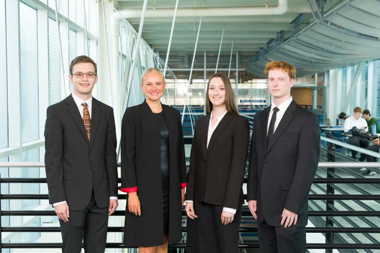 The four members of engineering senior design team 218 stand together on the third floor breezeway at the FAMU-FSU College of Engineering.