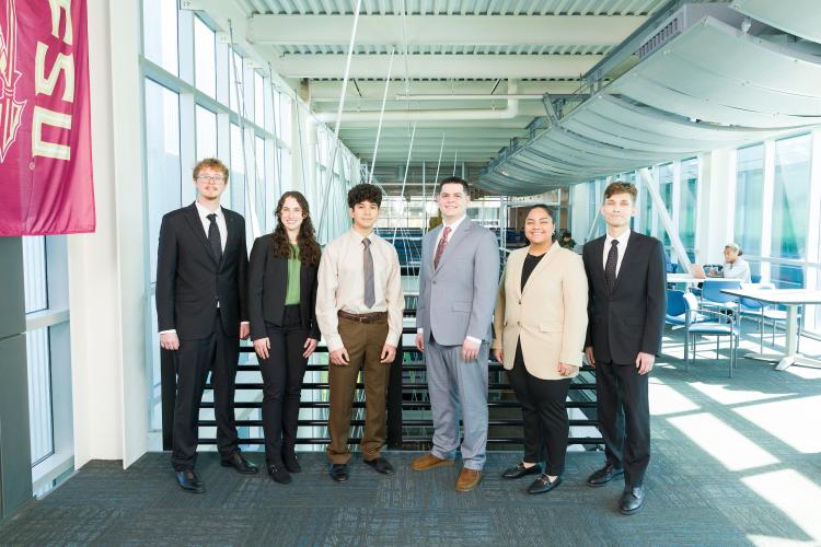 The six members of engineering senior design team 102 stand together on the third floor breezeway at the FAMU-FSU College of Engineering.