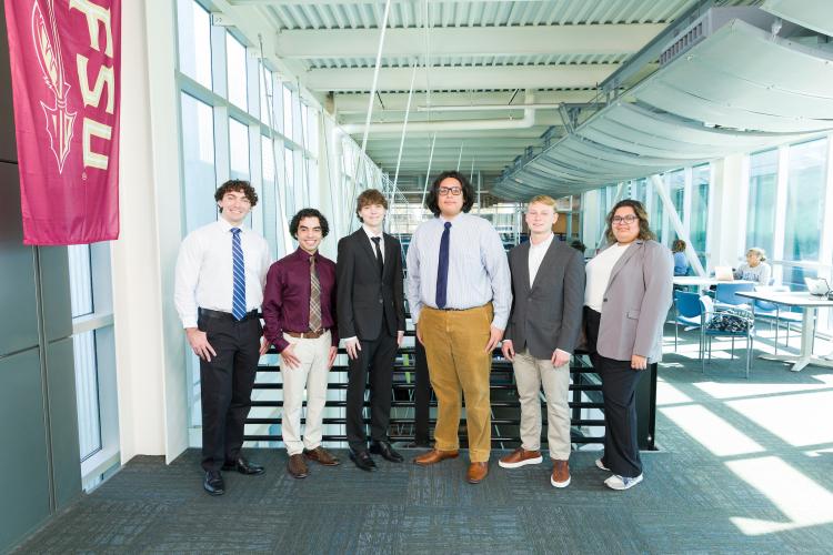 The six members of engineering senior design team 107 stand together on the third floor breezeway at the FAMU-FSU College of Engineering.