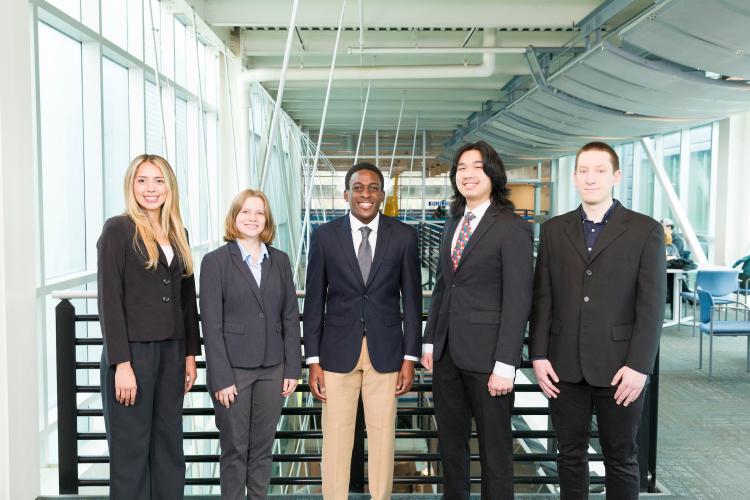 The five members of engineering senior design team 301 stand together on the third floor breezeway at the FAMU-FSU College of Engineering.
