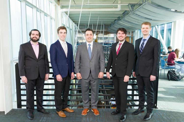 The five members of engineering senior design team 306 stand together on the third floor breezeway at the FAMU-FSU College of Engineering.