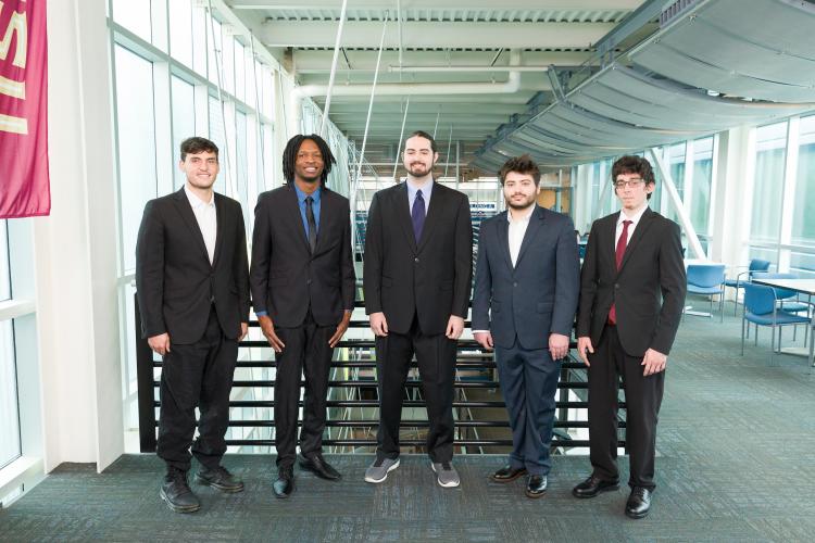 The five members of engineering senior design team 308 stand together on the third floor breezeway at the FAMU-FSU College of Engineering.