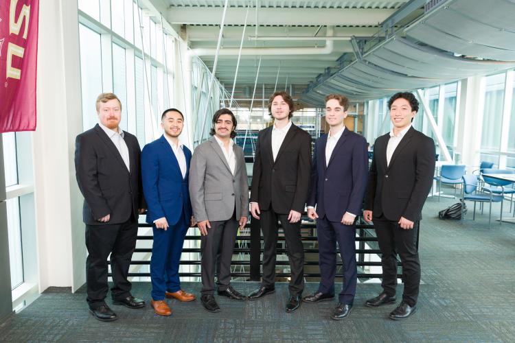 The six members of engineering senior design team 310 stand together on the third floor breezeway at the FAMU-FSU College of Engineering.