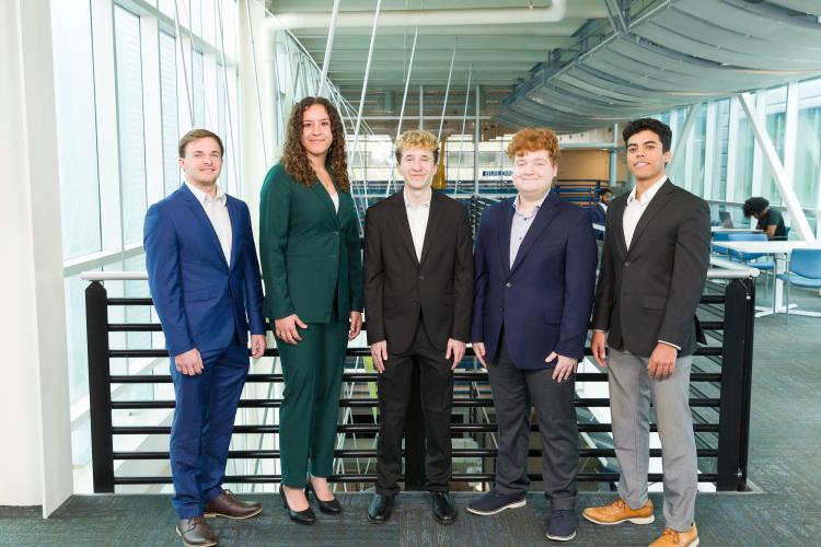 The five members of engineering senior design team 311 stand together on the third floor breezeway at the FAMU-FSU College of Engineering.