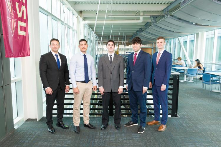 The five members of engineering senior design team 316 stand together on the third floor breezeway at the FAMU-FSU College of Engineering.