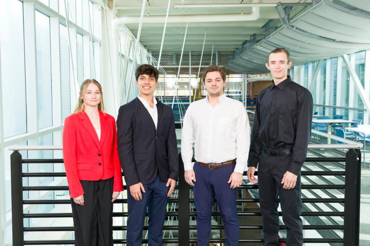 The four members of engineering senior design team 404 stand together on the third floor breezeway at the FAMU-FSU College of Engineering.