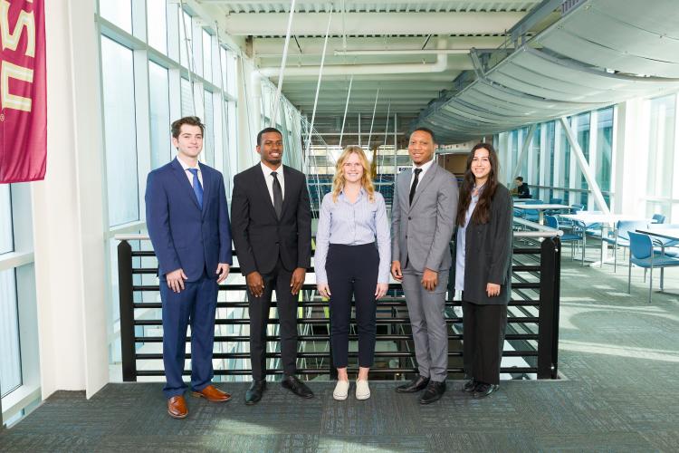 The five members of engineering senior design team 406 stand together on the third floor breezeway at the FAMU-FSU College of Engineering.