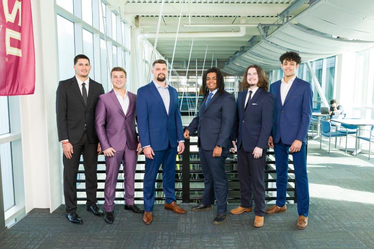 The six members of engineering senior design team 501 stand together on the third floor breezeway at the FAMU-FSU College of Engineering.