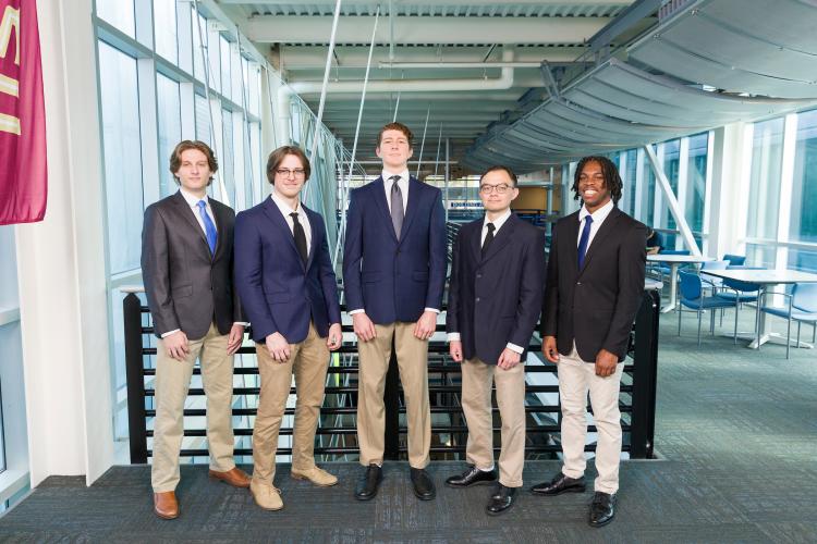 The five members of engineering senior design team 502 stand together on the third floor breezeway at the FAMU-FSU College of Engineering.