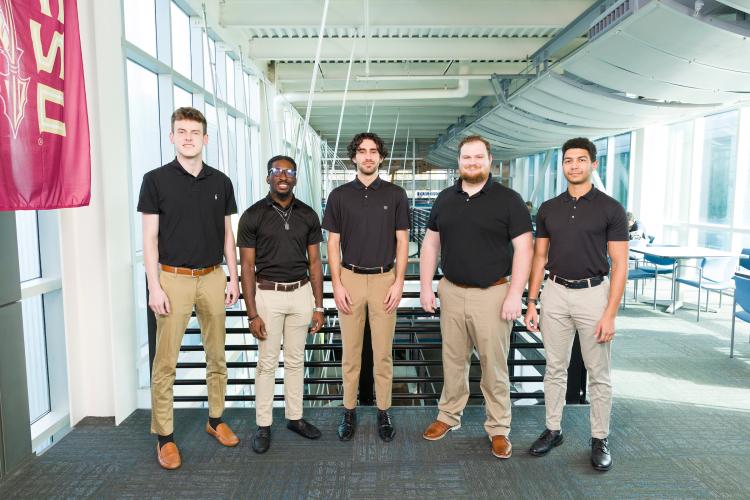 The five members of engineering senior design team 503 stand together on the third floor breezeway at the FAMU-FSU College of Engineering.
