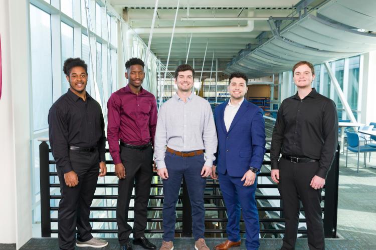 The five members of engineering senior design team 504 stand together on the third floor breezeway at the FAMU-FSU College of Engineering.