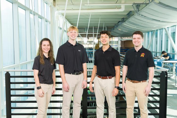 The four members of engineering senior design team 507 stand together on the third floor breezeway at the FAMU-FSU College of Engineering.