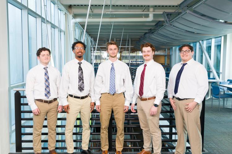 The five members of engineering senior design team 509 stand together on the third floor breezeway at the FAMU-FSU College of Engineering.