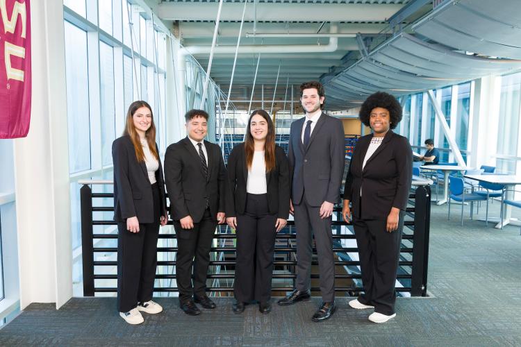 The five members of engineering senior design team 512 stand together on the third floor breezeway at the FAMU-FSU College of Engineering.