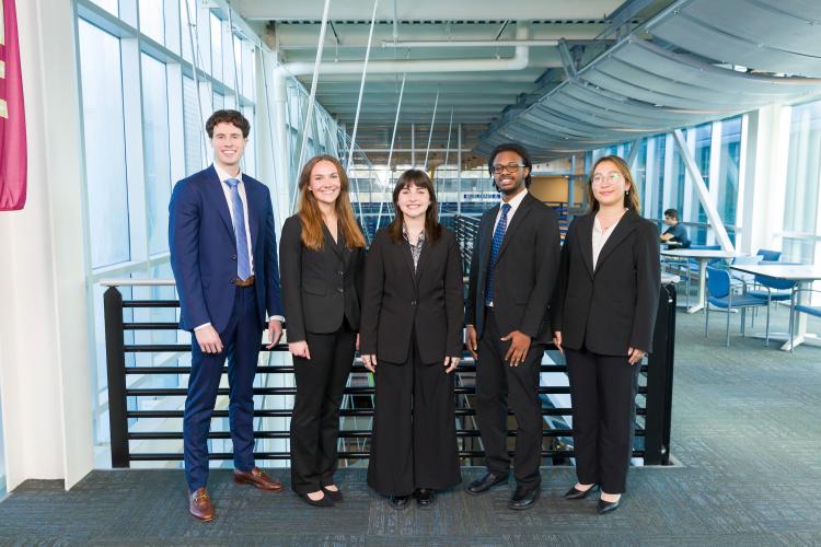 The five members of engineering senior design team 513 stand together on the third floor breezeway at the FAMU-FSU College of Engineering.
