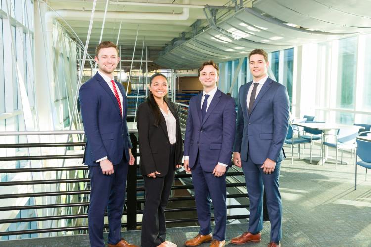The four members of engineering senior design team 519 stand together on the third floor breezeway at the FAMU-FSU College of Engineering.