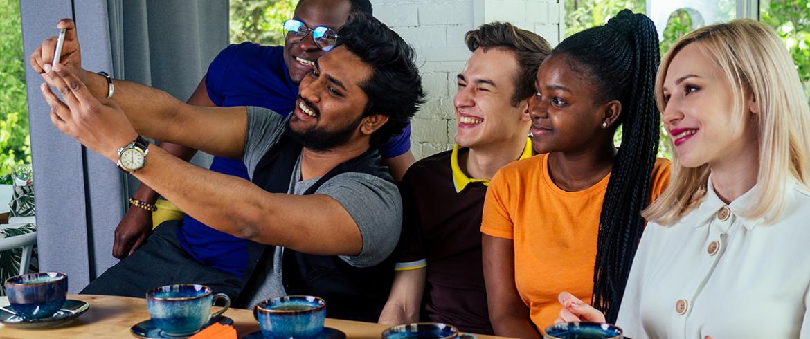 photo of international friends drinking tea and taking a group photo
