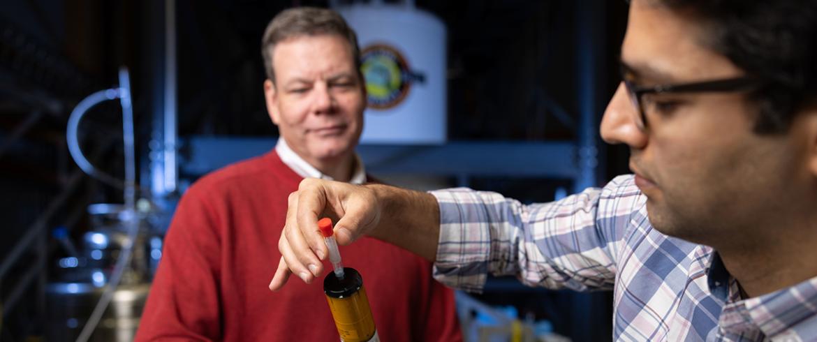 photo of engineering researchers loading probe for high magnet research