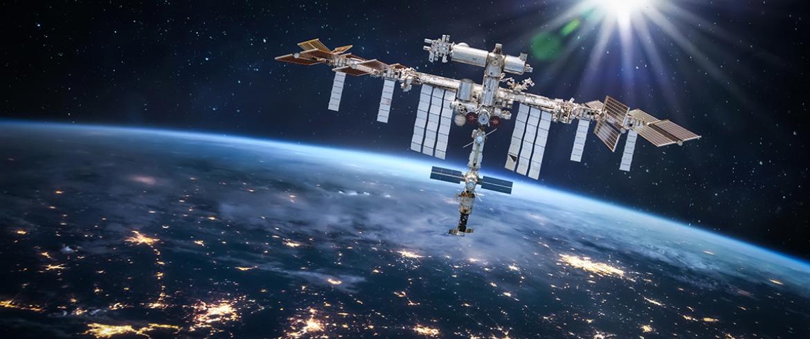photo of international space station with earth behind