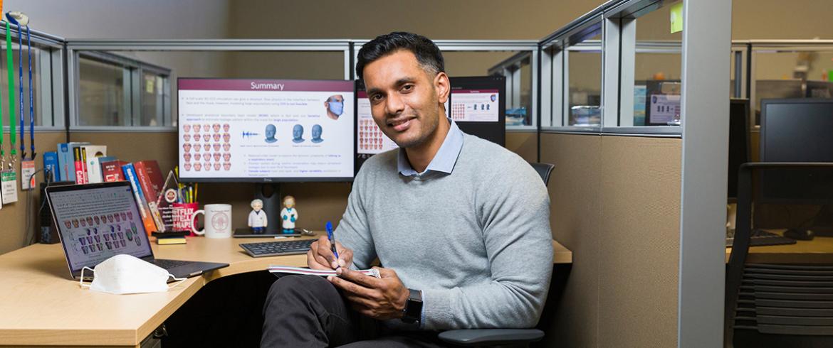 photo of mechanical engineering student akshay anand at his desk at famu-fsu college of engineering