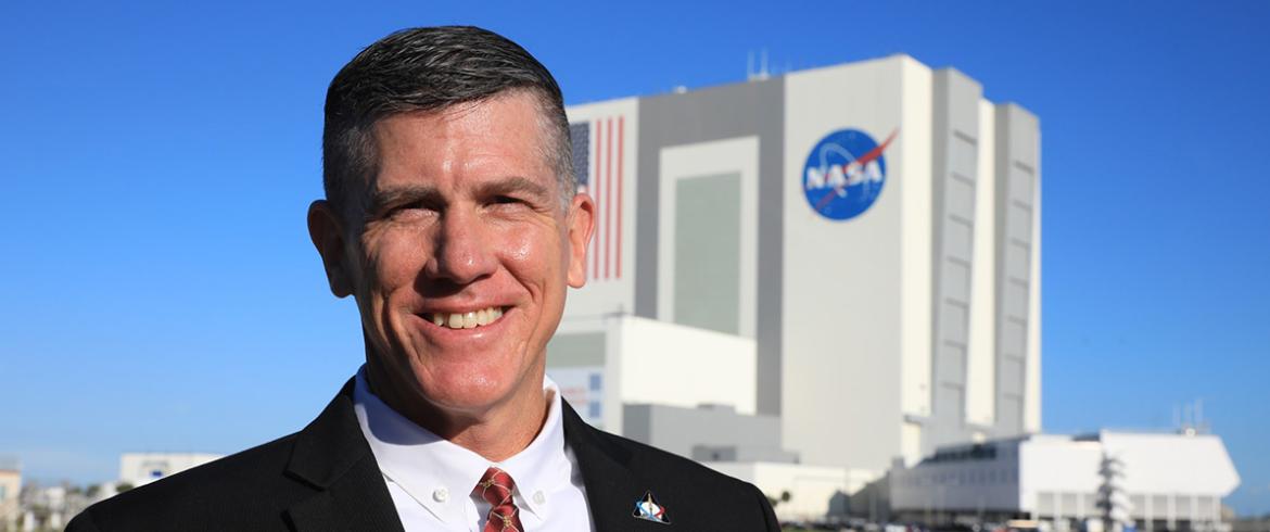photo of famu-fsu engineering alumnus jeremy graeber in front of nasa launch building
