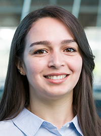 smiling woman with long dark hair and blue shirt