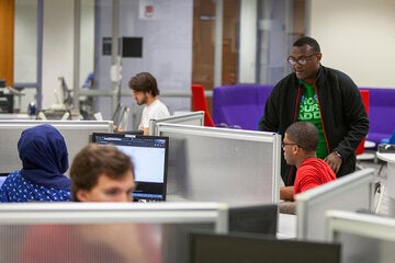 students in library sitting at carels