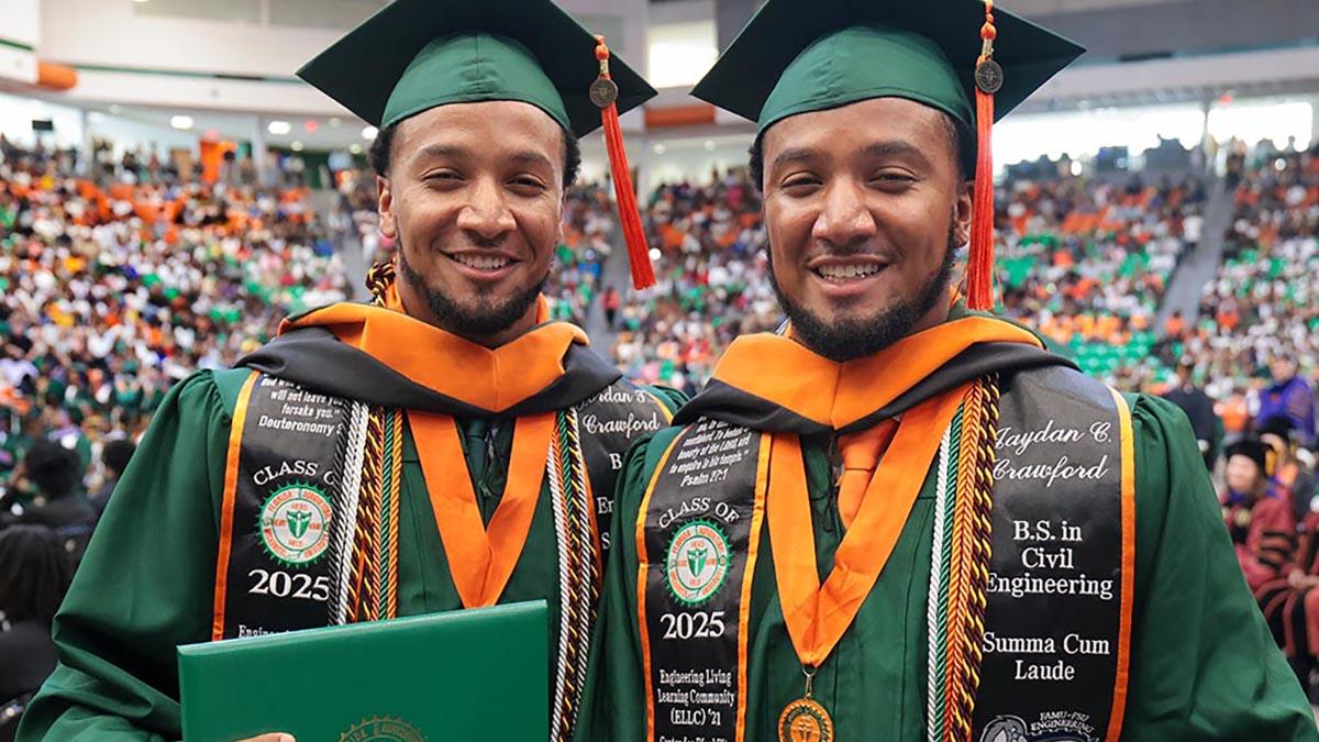 photo of twin men in famu graduation regalia holding diplomas