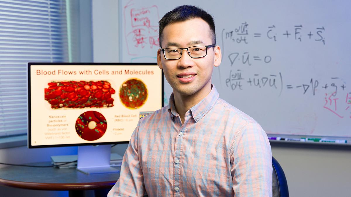 photo of famu-fsu engineering professor leo liu in front of monitor and white board